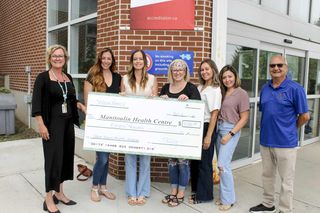 Summer (Chatwell) Seguin, who is originally from Gore Bay, along with members of her family and friends present a donation in
