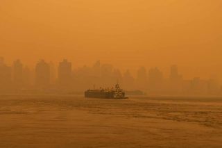 An apocalyptic view of the Manhattan skyline from the East River due to smoke from Canadian wildfires last week. Shutterstock