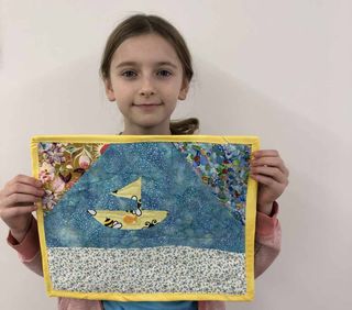 Allie Jameson shows off her quilt.