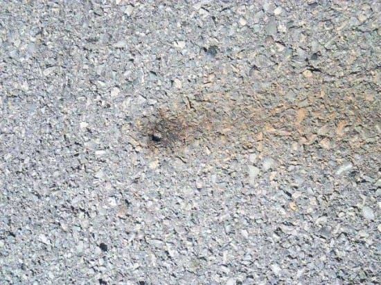 Tiny holes show deterioration of Hwy 6 pavement