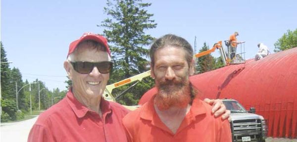Man so passionate about painting the Providence Bay curling rink red he gets right into the spirit