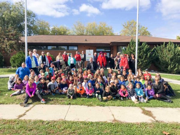 Assiginack students and community members plant the Canada 150 garden