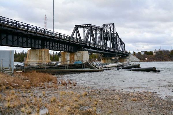 Decommissioned cages drift into bridge in high winds