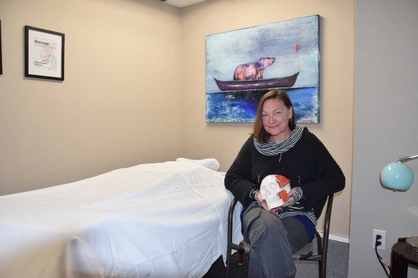Cheryl Mazak RMT holds one of her favourite props in her new office in Little Current. Ms. Mazak specializes in treatment pla