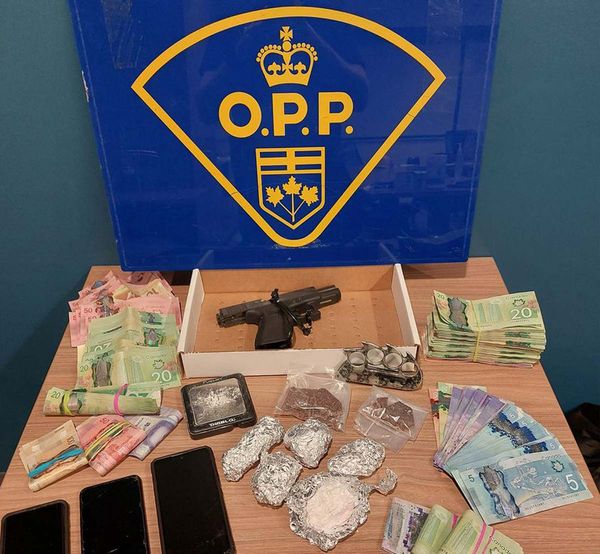 The haul of drugs, weapons and cash are displayed in this photograph.