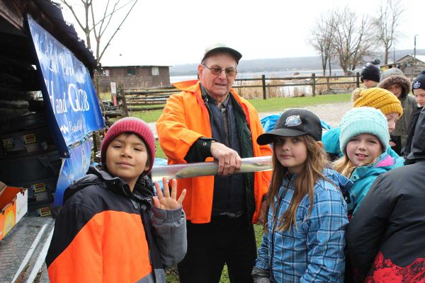 Bill Strain of the Little Current Fish and Game Club introduces the students to a lamprey eel. An invasive species of aquatic