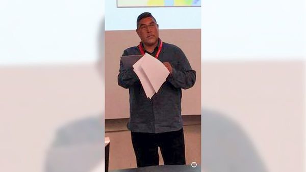indigenous man lecturing to a university class