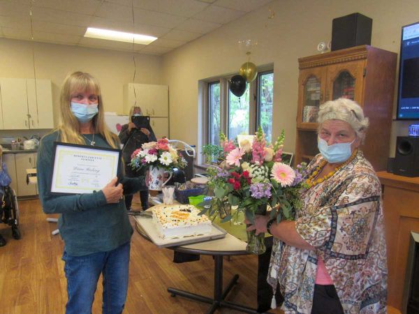Mantoulin Lodge health care aid worker Diane Riching, left, receives a Roberta Jarlette Award from Gloria Hall, Lodge activit