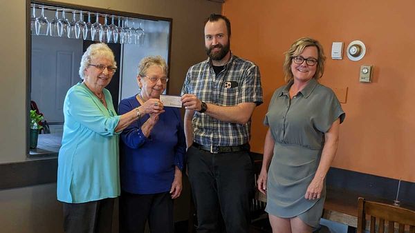 Members of the Auxiliary and the Manitoulin Health Centre hold a cheque passing.