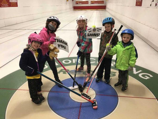 THANK YOU, LIONS! Youngsters in the Providence Bay Youth and Junior Curling Club are all smiles and hold up thank you cards t