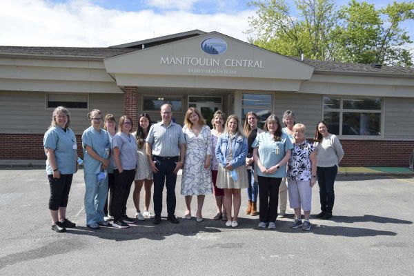 Members of the Manitoulin Family Health Team gather in front of the office for a group photo with Smith Family Foundation rep
