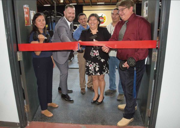From left, Wiikwemkoong education portfolio holder Marcia Trudeau-Bomberry, teacher/mentor Cameron Beaudry (cutting the ribbo