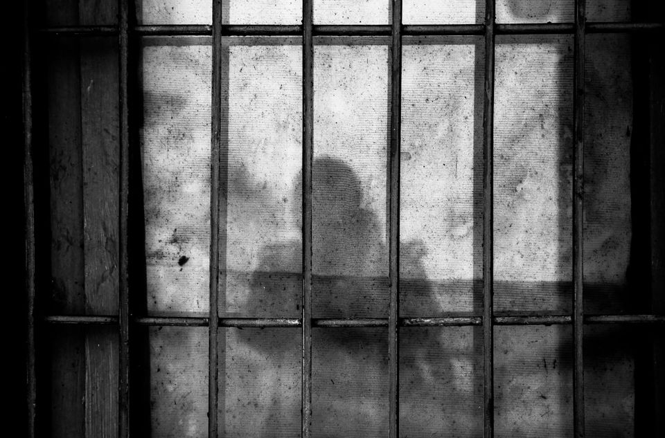 The woman cloaked in gray