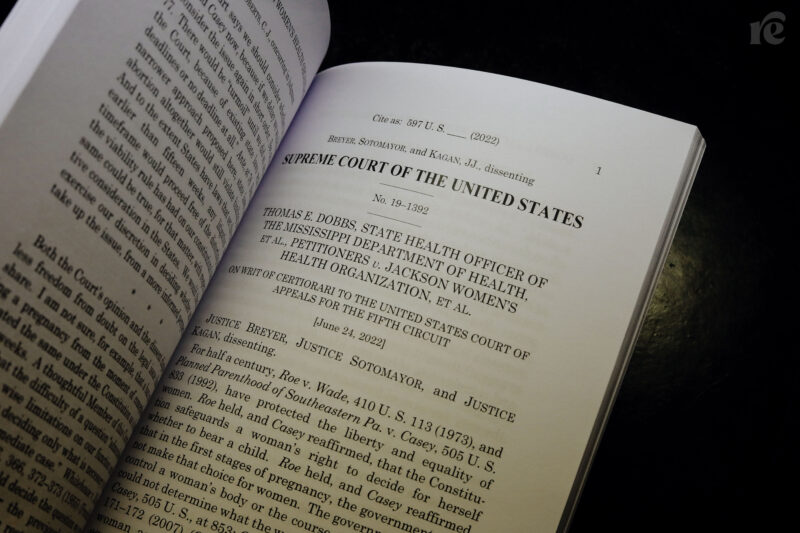 A photograph of an official copy of the Supreme Court's decision in Dobbs, on a dark background.