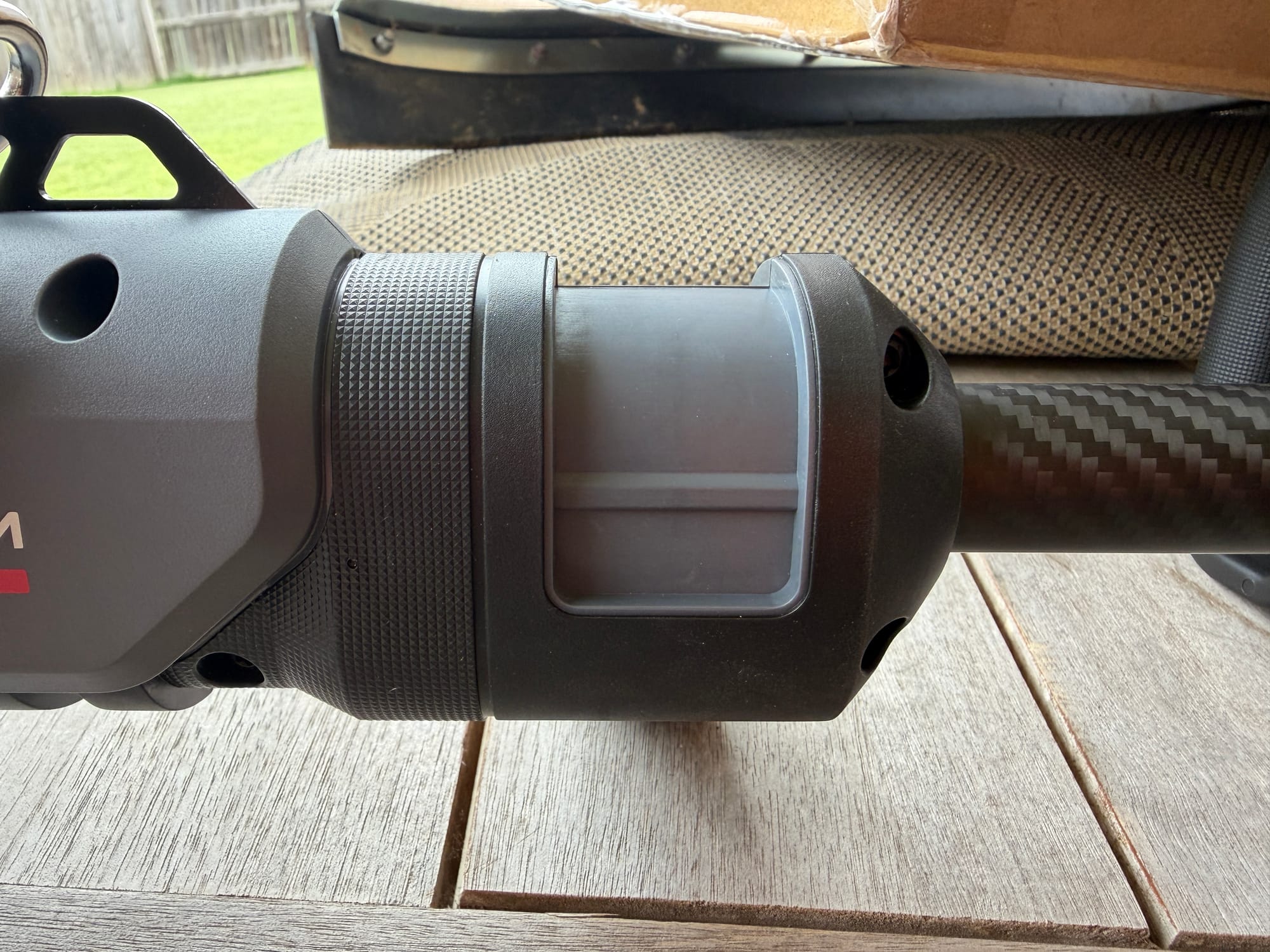 Adjustable locking lever and grip where the shaft connects to the trimmer body