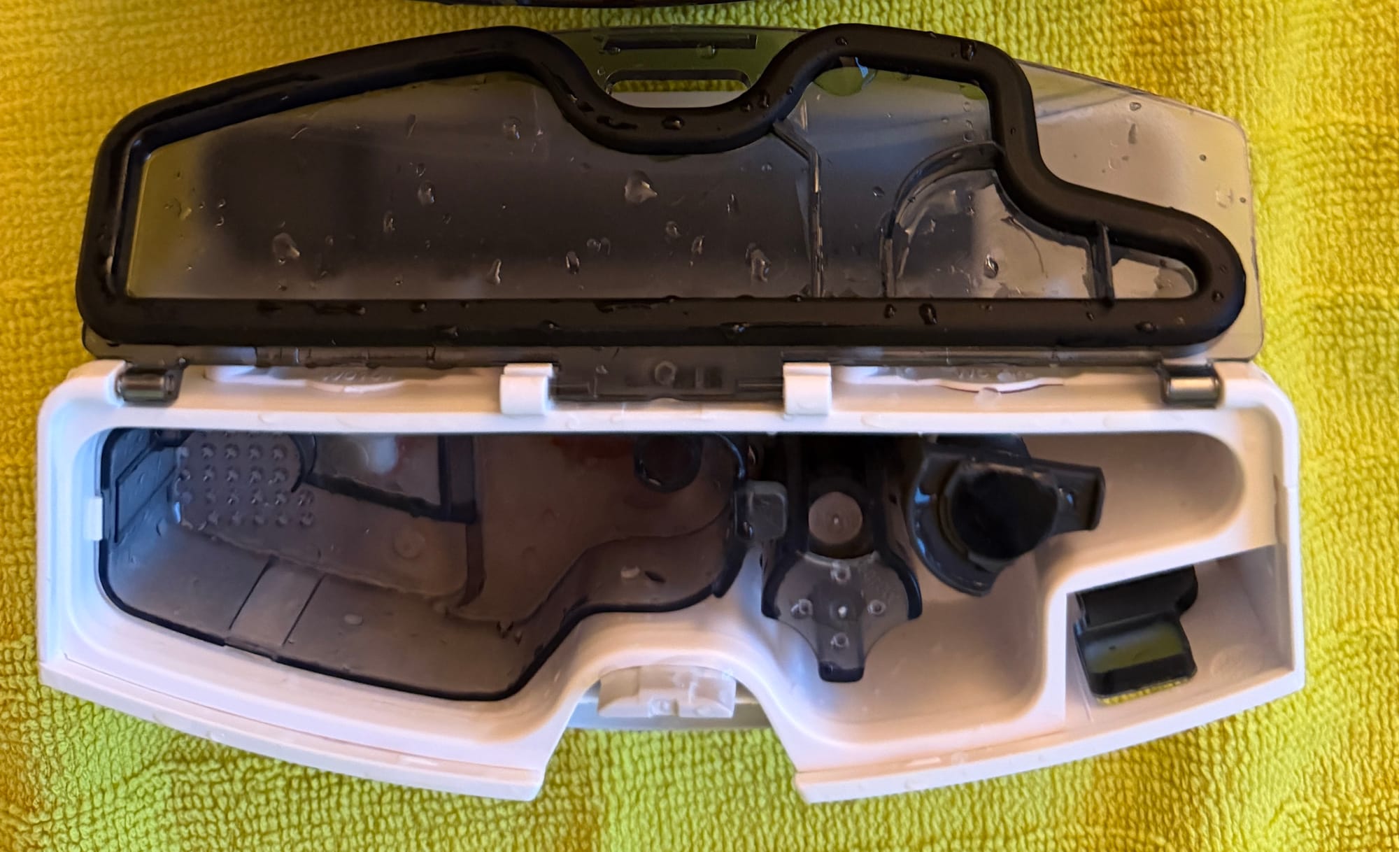 Curv 2 Flow's clean and dirty water reservoirs removed for cleaning.