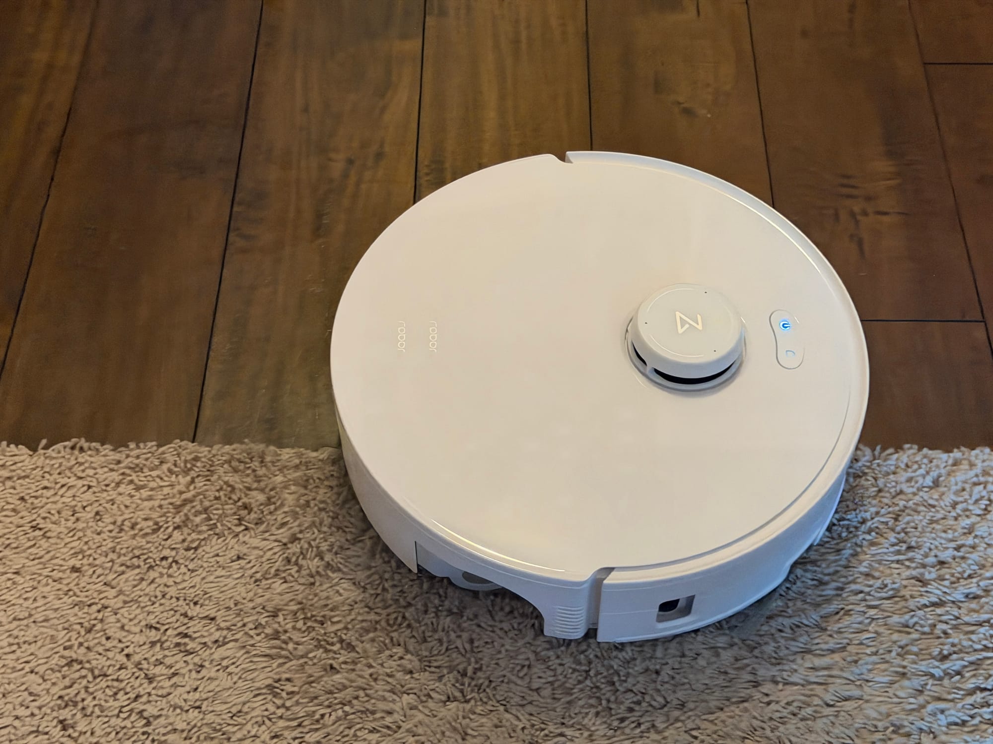Curv 2 Flow robot vacuum crossing a doorway threshold.