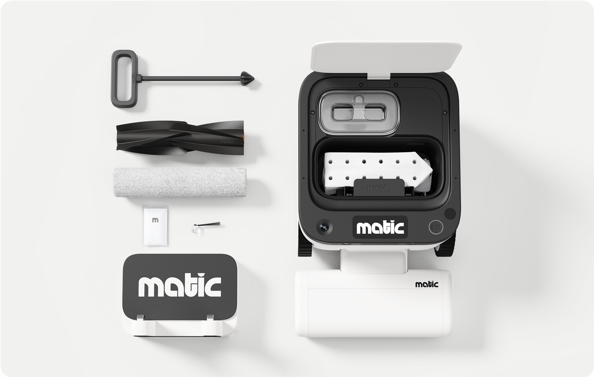 Top-down view of the Matic robot vacuum with its lid open alongside the removable brush, mop roller, cleaning tool and other accessories.