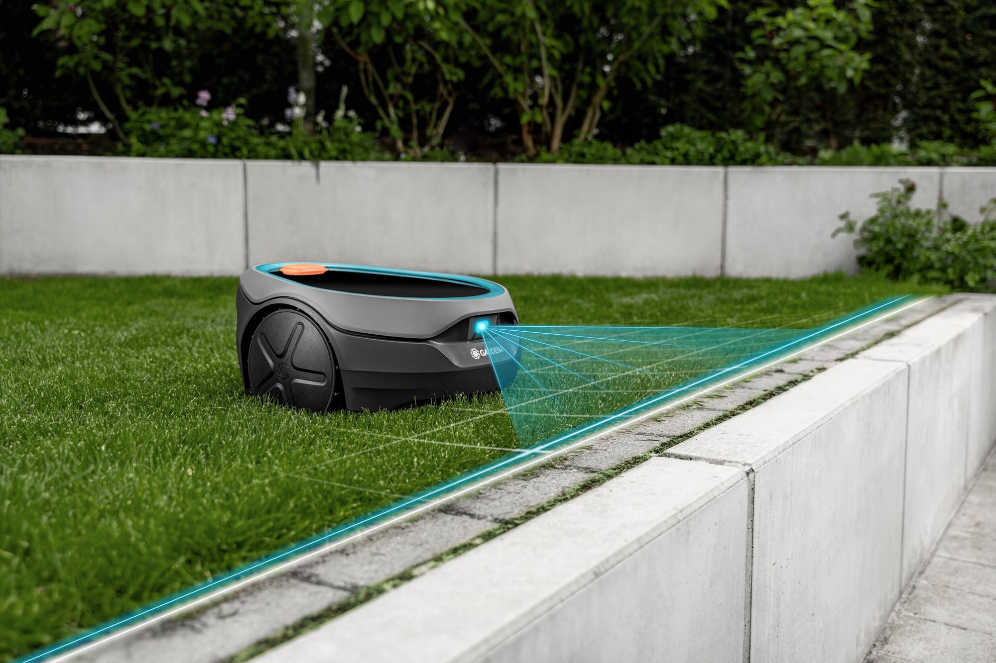 Gardena Sileno Sun robotic mower using camera-based navigation to follow the edge of a lawn beside a concrete wall.
