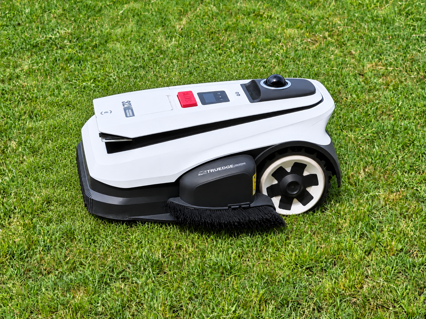 Ecovacs GOAT A2000 LiDAR Pro robotic mower cutting grass in a fenced backyard. Trimming beside the fence