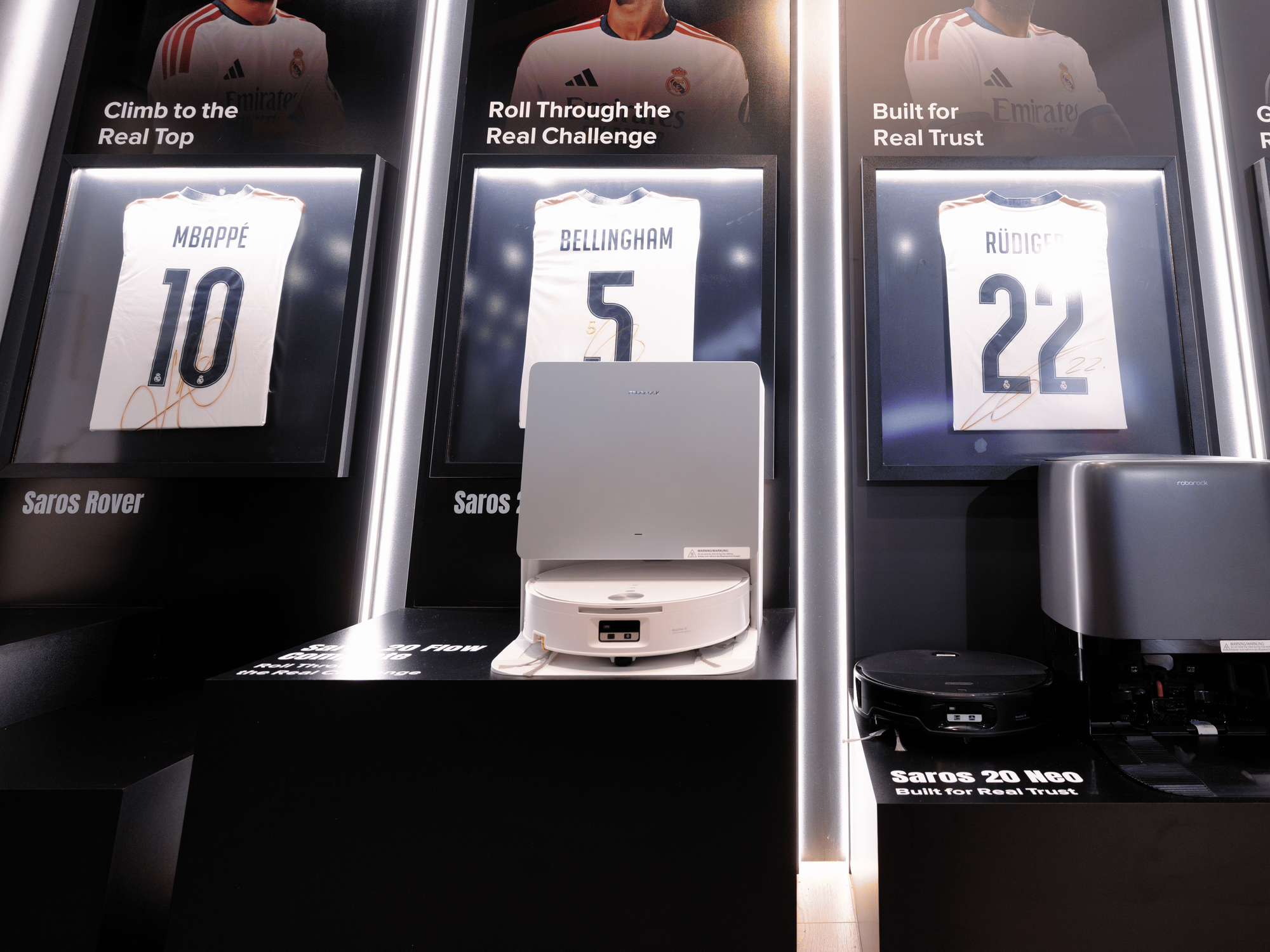 Roborock Saros 20 Flow robot vacuum and docking station displayed at IFA 2026 beside the Saros 20 Neo.