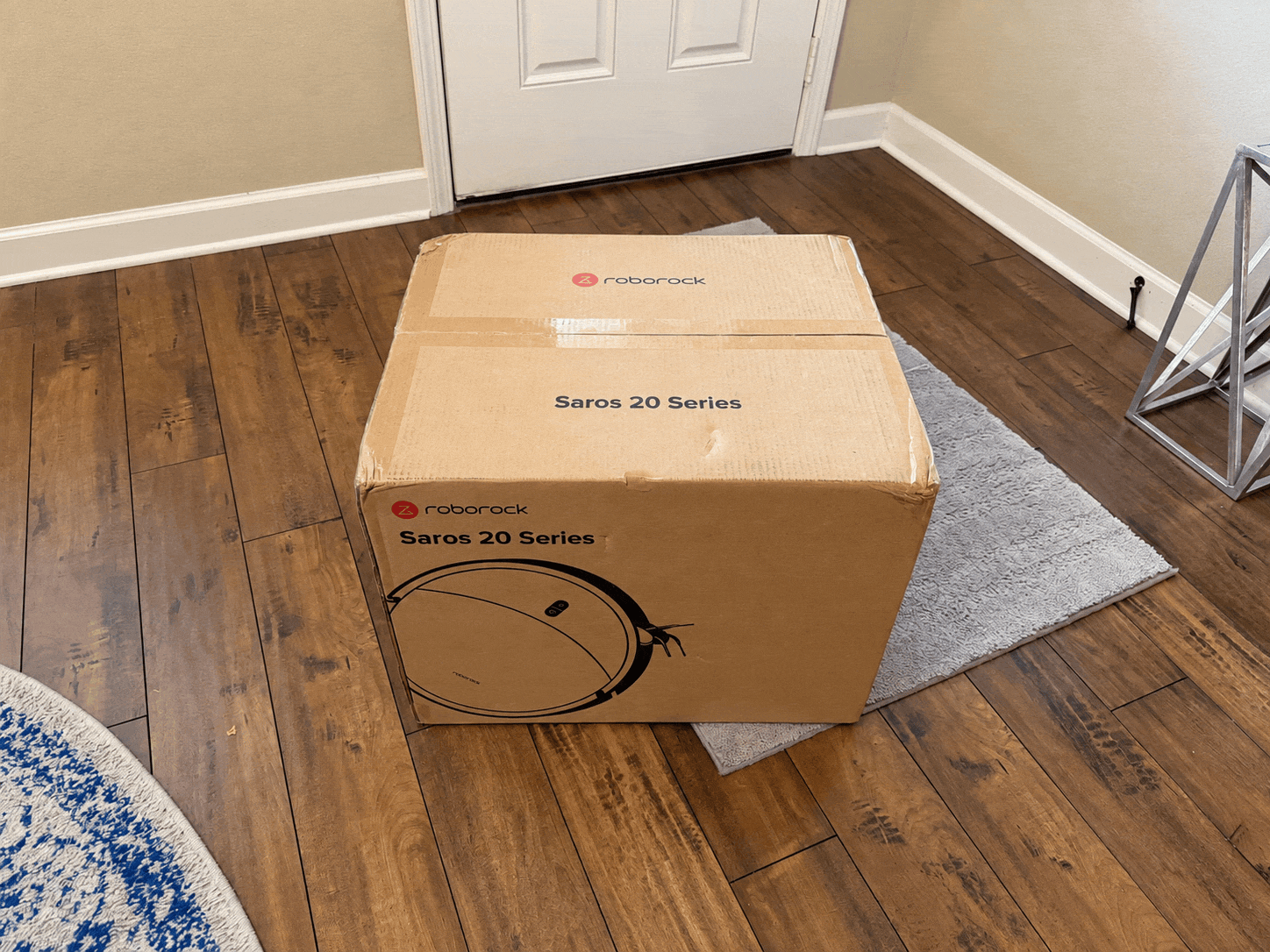 Roborock Saros 20 robot vacuum, multifunction dock, mop pads, dock base and setup materials being unpacked from the box.