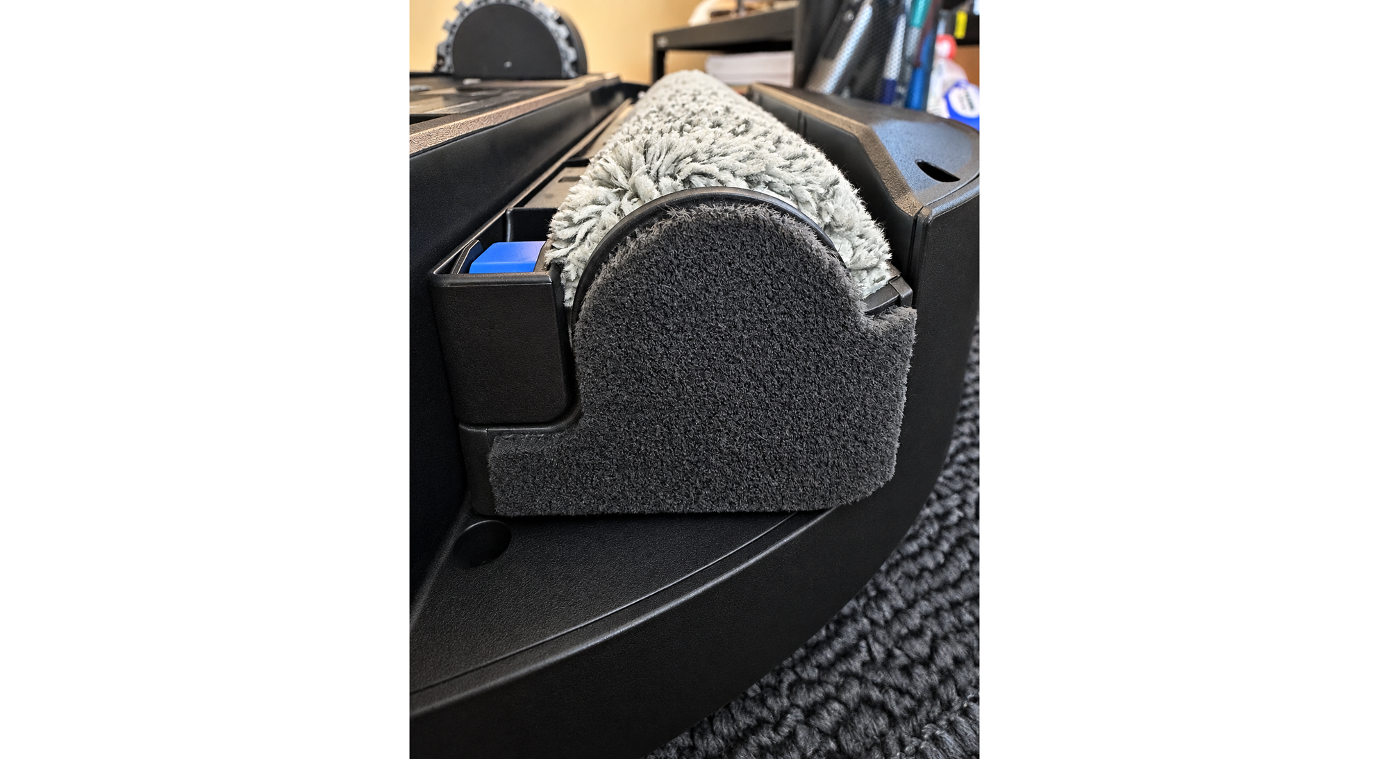 Close-up of hair and debris wrapped around the end of the Ecovacs Deebot T90 Pro Omni roller mop.