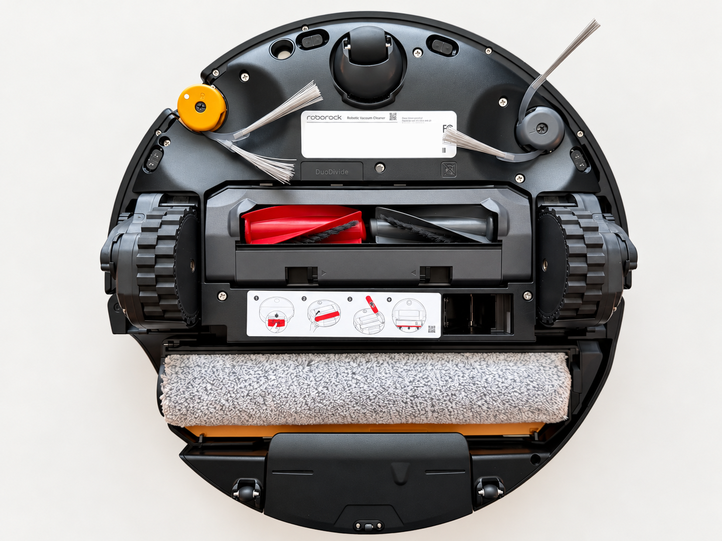 Underside of the Roborock Saros 20 Flow robot vacuum showing its roller mop, red and black DuoDivide brush, two side brushes and drive wheels.