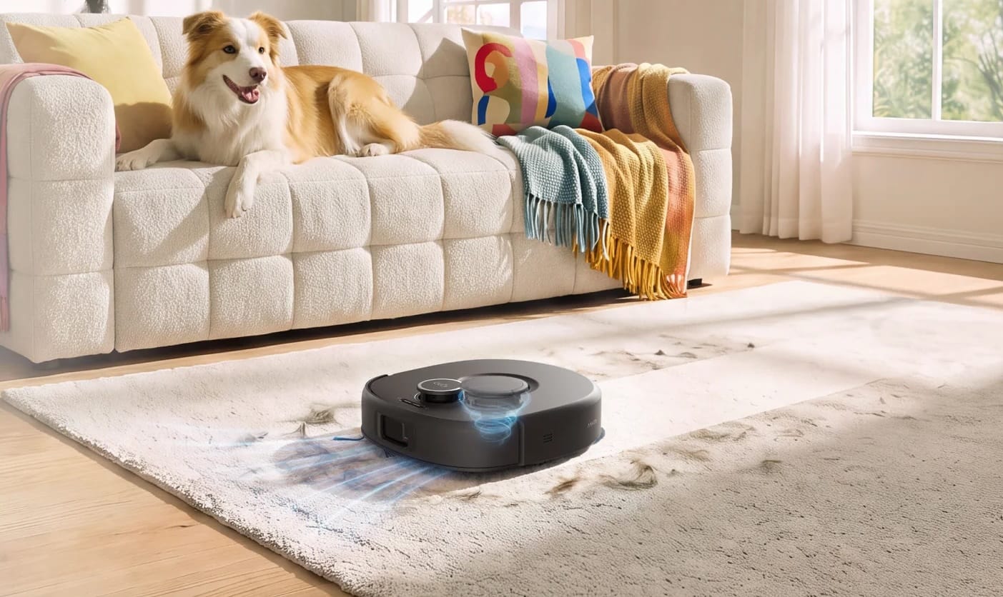 Eufy Omni C30 robot vacuum cleaning pet hair from a light-colored carpet while a dog rests on a nearby sofa.