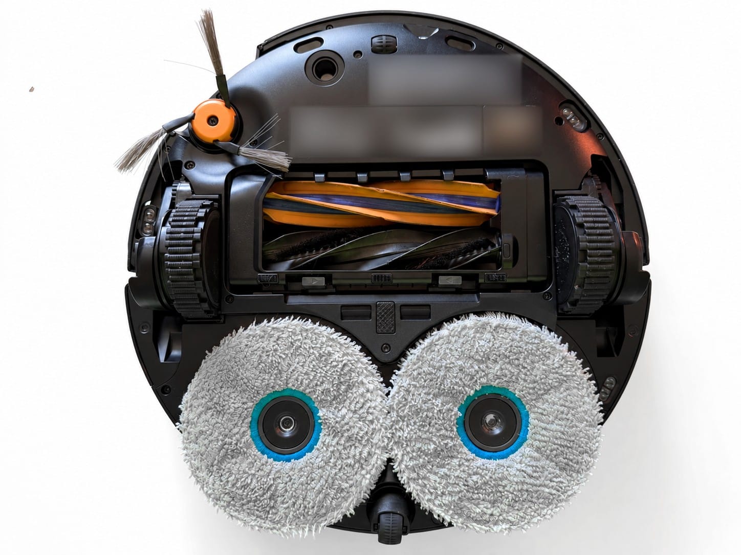 Underside of the Dreame X60 Max Ultra Complete showing the side brush, dual anti-tangle rollers, drive wheels and two rotating mop pads