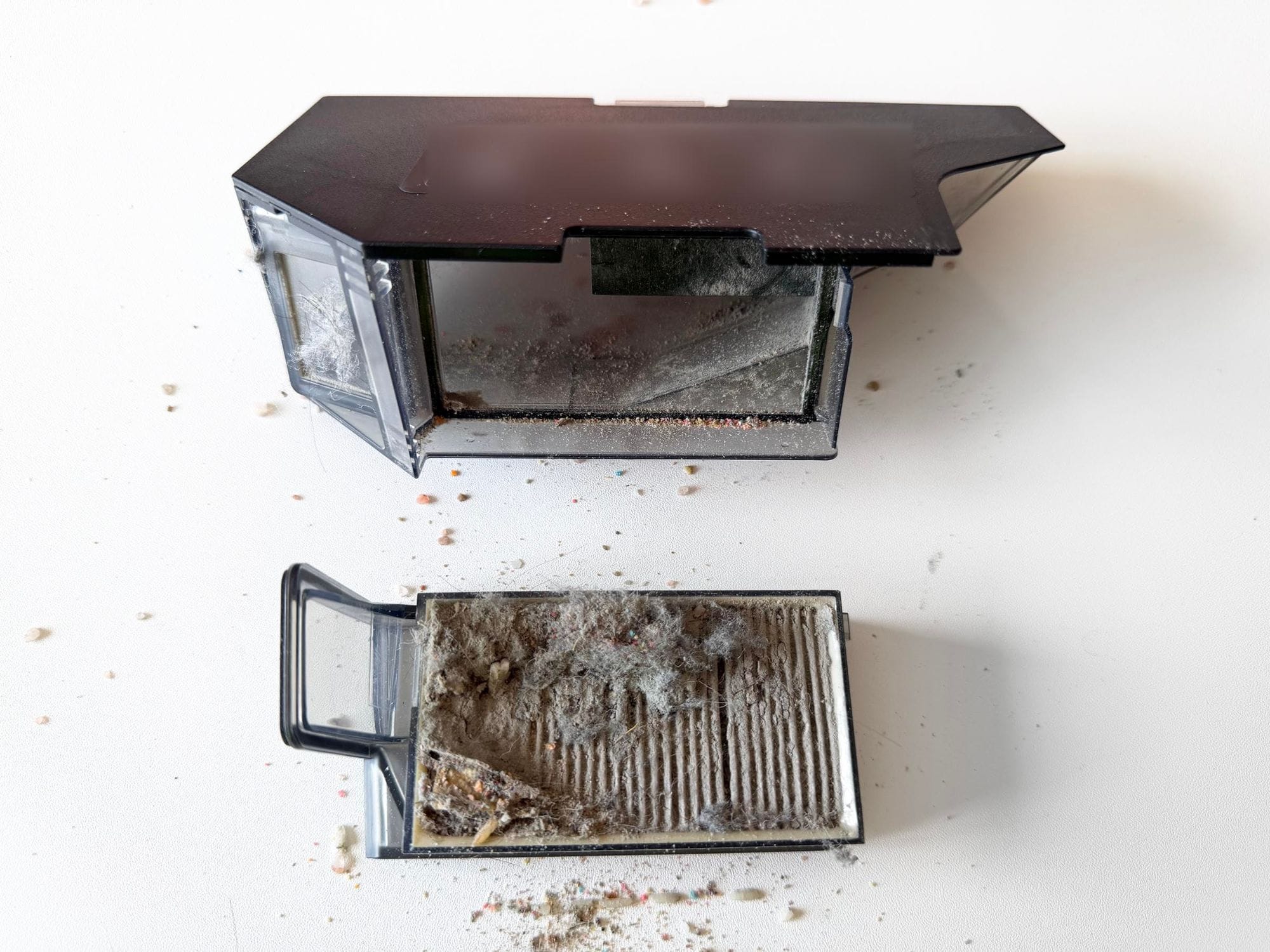 Dreame X60 dustbin opened with its dust-clogged filter removed