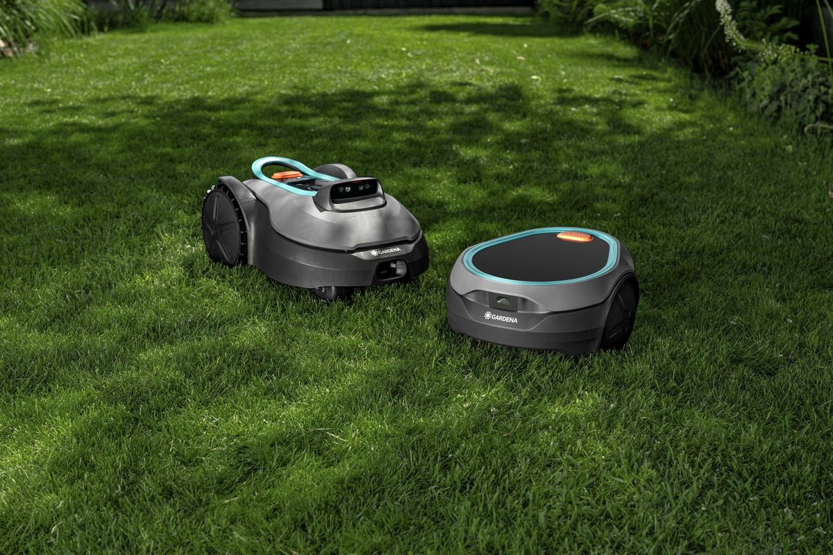 Gardena Sileno Evolve and Sileno Sun robotic lawn mowers sitting on a green lawn.