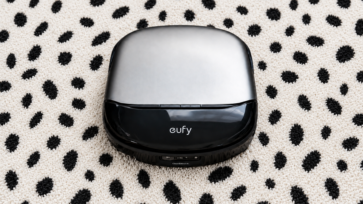 Eufy Omni S2 robot vacuum on beige carpet, viewed from the front with its silver top and black front panel visible.