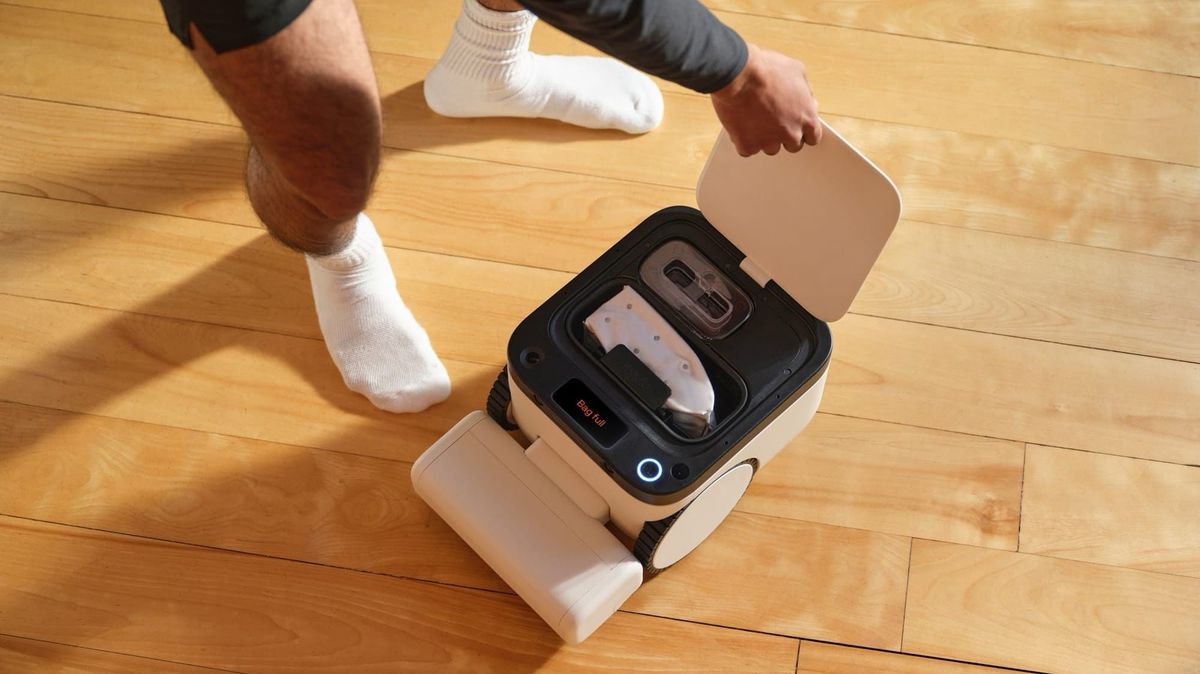 Matic robot vacuum with its top compartment open, showing the disposable debris bag inside.