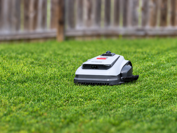 Front three-quarter view of the Ecovacs GOAT A2000 LiDAR Pro robotic mower on green grass.
