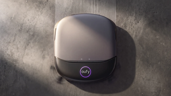 Eufy Omni S2 Pro robot vacuum with purple UV-C lighting on a dark floor.