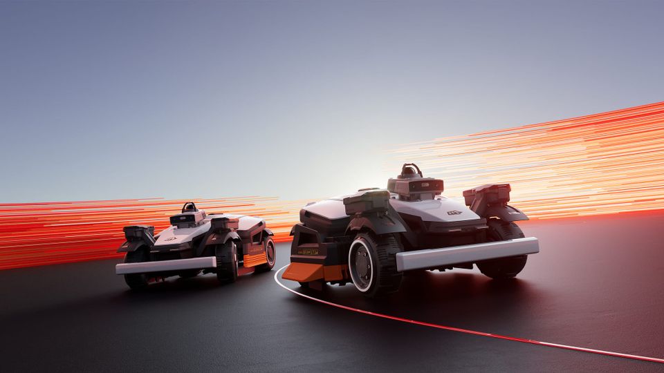 Two Mammotion LUBA 4 AWD robotic lawn mowers shown side by side in a promotional image with red light trails in the background.