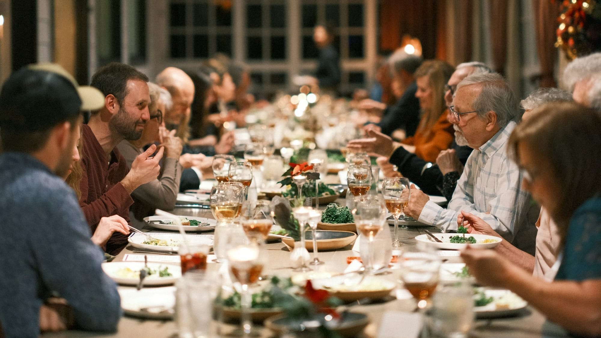 A group of people sitting at a long table.