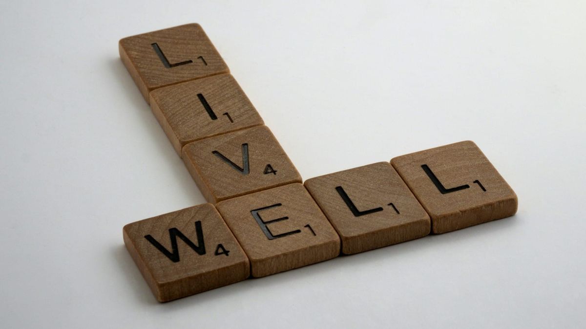 Live well spelled out with wooden scrabble pieces.