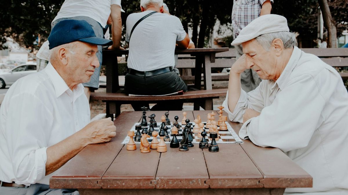 Two older men playing chess.