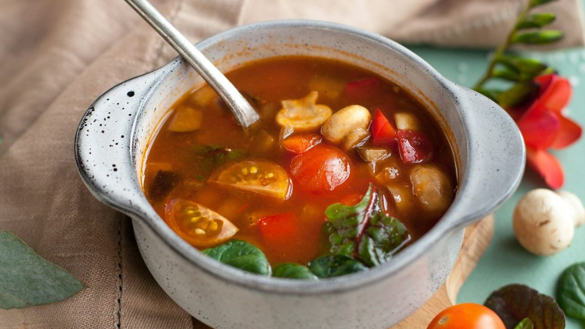 Minestrone or ribollita soup in a white bowl.