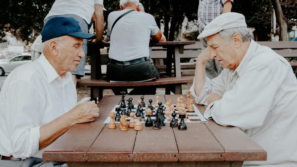 Two older men playing chess.