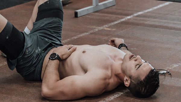 Athlete lying of floor after a hard workout.