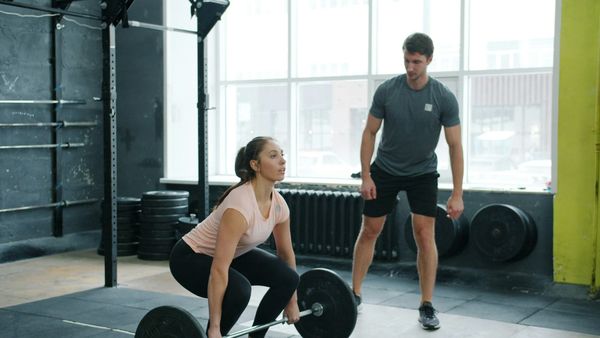 Women deadlifting with pesonal trainer