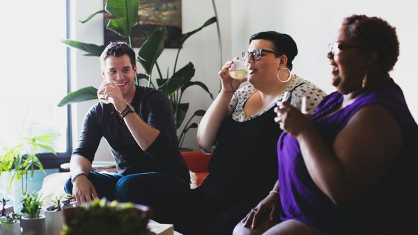 Young male socialising with two overweight women.