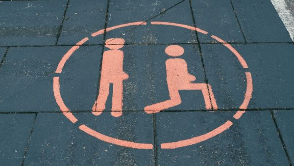 Lunge exercise painted onto a pavement.