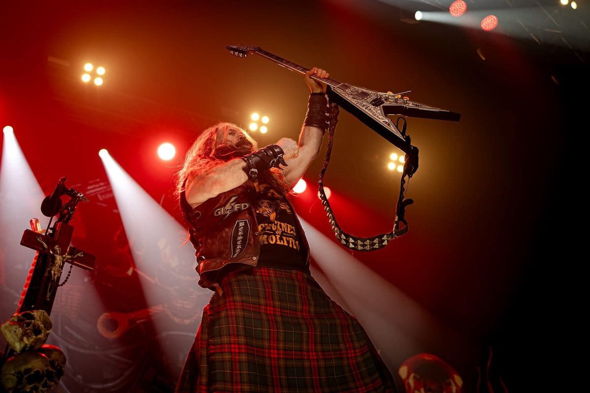 Zakk Wylde raises his guitar in triumph in front of a packed crowd at Boeing Center at Tech Port in San Antonio, Texas.