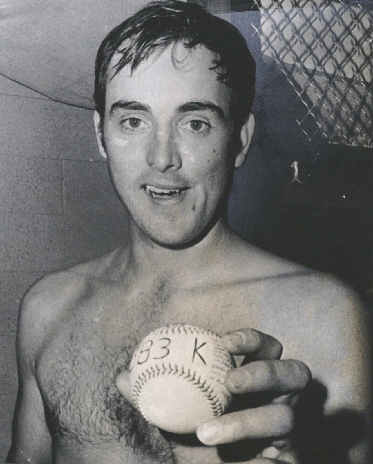 The artifact: Ryan in the clubhouse with a baseball marked