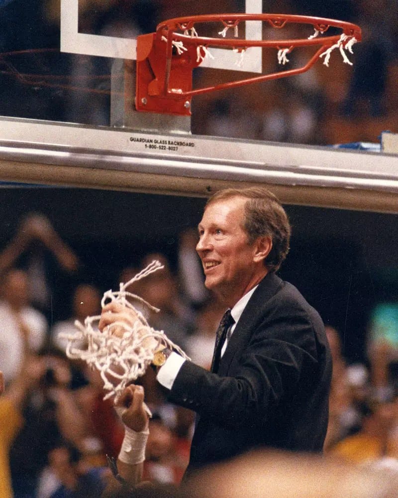Fisher cuts the net — champion before his first regular-season win.