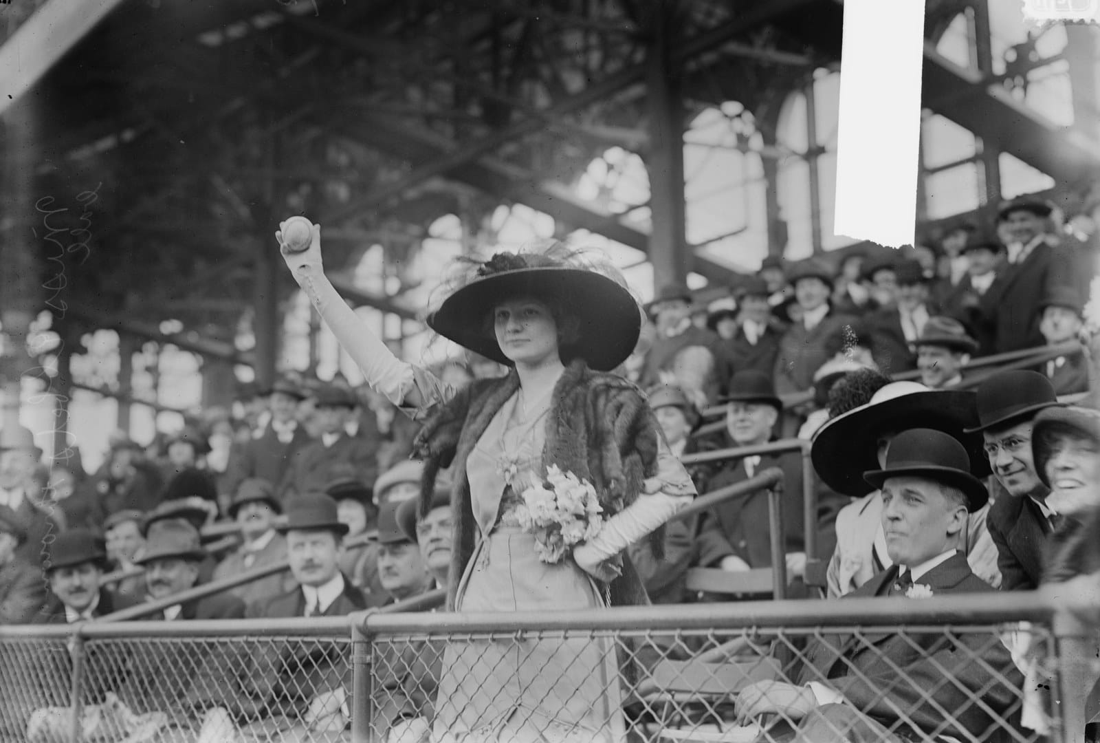 Genevieve Ebbets, daughter of the owner, throws the first pitch in park history.